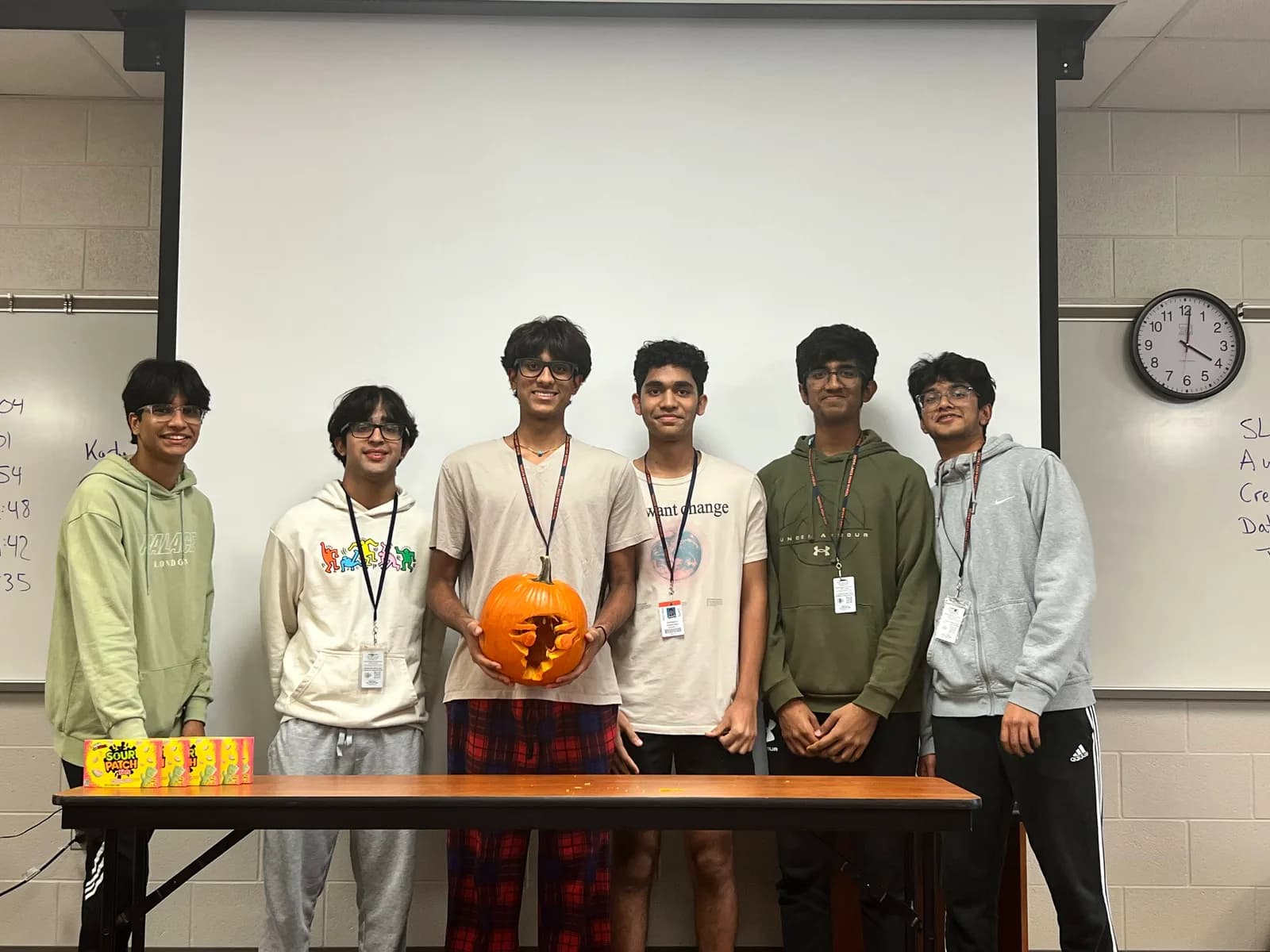 Team presenting their carved pumpkin design