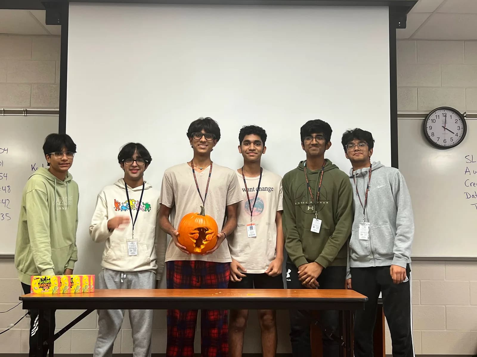 Members displaying the finished pumpkin carving