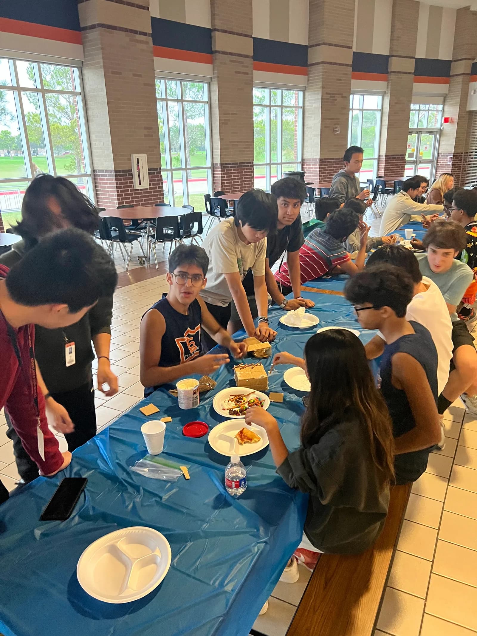 Members building along the long cafeteria tables