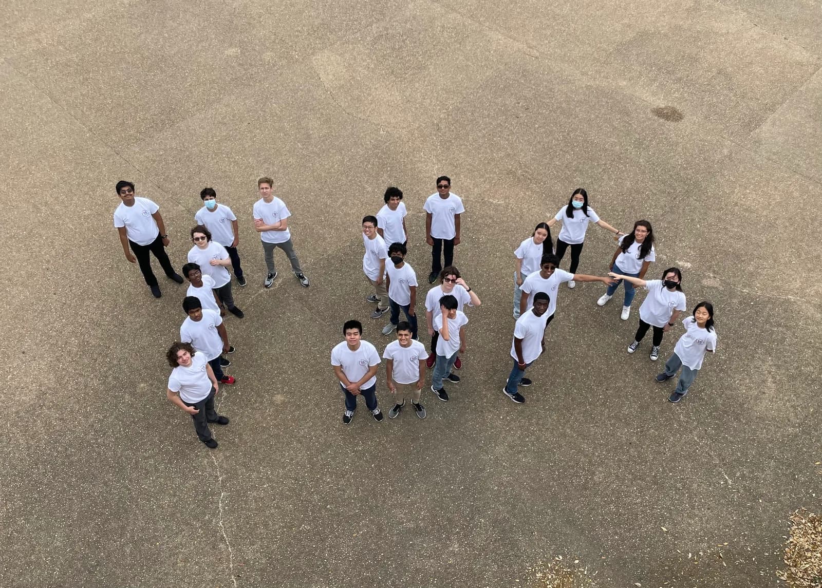 Aerial shot of members arranged in formation on the pavement